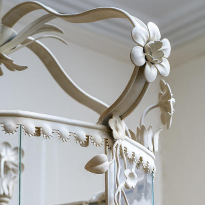 Ibthorpe Lantern detail - The Ibthorpe Lantern is made from delicate steel components and pressed steel swags, hand-painted in an Ivory White finish. The lantern is fitted with sectioned glass panels.