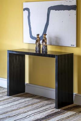 Ripley Console Table -A compelling, minimalist design, this table stands out with its clean lines and amara veneer finish. The initial inspiration for it came from a traditional Ming piece of furniture, a period renowned for its emphasis on craftsmanship and form.