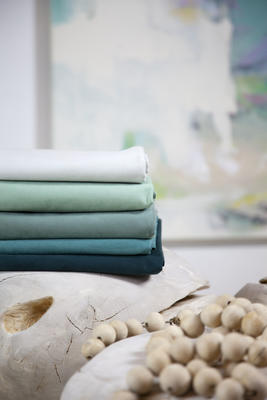 Nature inspired shades of Ultrasuede sea-greens paired with weathered wood.