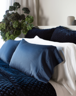 Bria pillowcases in White and Midnight with silk velvet quilted coverlet in Midnight.