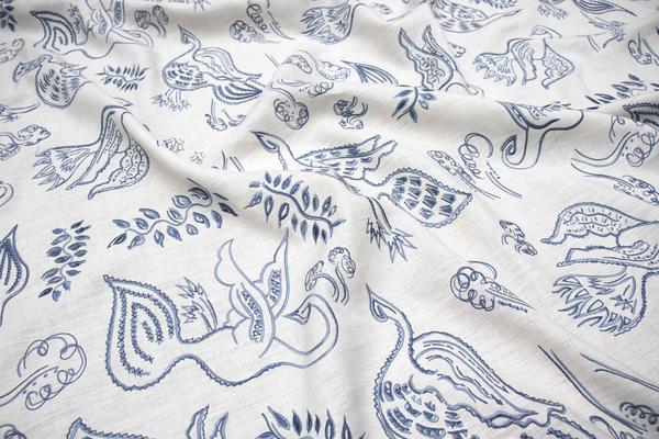 Avem in Porcelain Blue: A snapshot from an autumn walk through the English countryside, our Avem linen drapery is both scenic and sweet. Distilled through a dream and captured as an original work hand-painted in ink, the pattern presents playful partridges and pheasants mid-flight, surrounded by leaves dancing on an updraft. A 100 percent linen-ground cloth that boasts delicate embroidery by our artisans in India, its beauty is in the textural nuances. When the morning light filters through Avem, or a breeze from the window fills its folds, the birds take wing once more.