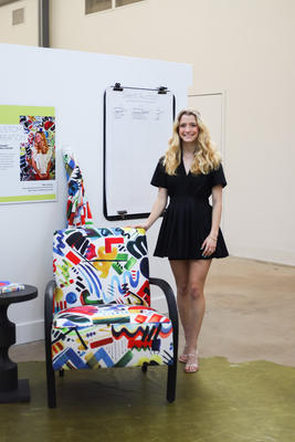 Artist and high school student Isabella Rocque with Universal Furniture’s Bahia Honda Accent Chair upholstered in a fabric of her design. The one-of-a-kind chair was auctioned off during High Point Market with all proceeds benefitting NY School for the Deaf in honor of Isabella’s grandmother.
