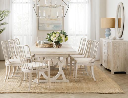 The Topsail rectangle dining table includes two 12-inch leaves that extend the table from 86 inches to 122 inches when both are in place; 6350-75207-80 will accommodate up to eight guests. The Bimini spindle dining chairs are available in arm and side chair versions with removable seat cushions in the neutral performance fabric Oyster. The featured Surf finish is crafted in a whitewashed oak.