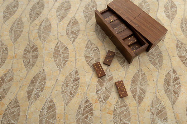 Cocoon, a hand-cut mosaic shown in honed Jerusalem Gold, Lavigne and Travertine Noce, is part of the Biome collection by New Ravenna.