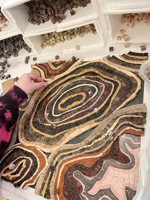 Geode, a hand-cut stone mosaic shown in polished Rojo Alicante, Saint Laurent, Emperador Dark, Giallo Reale, Crema Valencia, Travertine Noce, Aurum, Aegean Brown, Red Lake, honed Jerusalem Gold and Nero Marquina, is part of the Biome collection by New Ravenna.