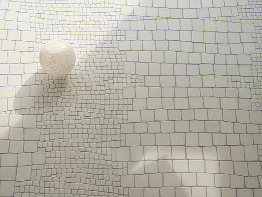 Reptile, a hand-chopped mosaic shown in tumbled Dolomite, is part of the Biome collection by New Ravenna.