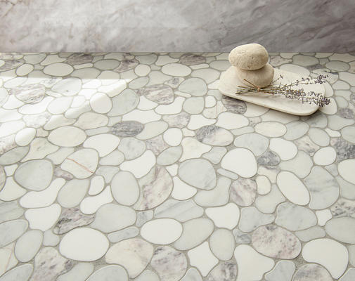 Riverbed, a waterjet mosaic shown in honed Lavender Mist, Dolomite, Afyon White, and tumbled Carrara, is part of the Biome collection by New Ravenna.
