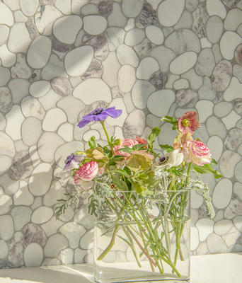Riverbed, a waterjet mosaic shown in honed Lavender Mist, Dolomite, Afyon White and tumbled Carrara, is part of the Biome collection by New Ravenna.