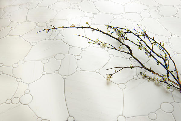 Seafoam, a waterjet mosaic shown in Venetian honed Dolomite, is part of the Biome collection by New Ravenna.