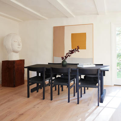 Shinto dining chairs in black leather on a charcoal frame surrounding Kyoto dining table