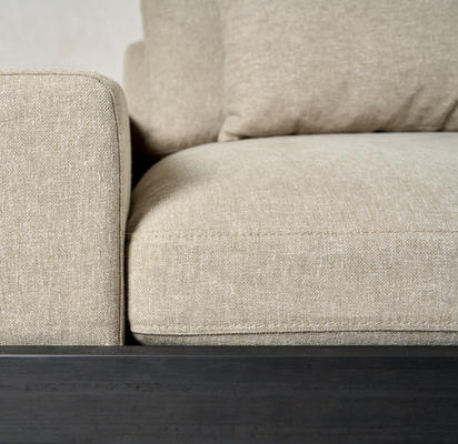 Detail of the Kyoto sofa in stone Belgian linen on a charcoal frame