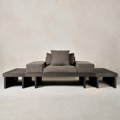 Kyoto lounge chair in charcoal Belgian linen on a charcoal birch frame flanked by Kyoto side tables in a charcoal watercolor finish