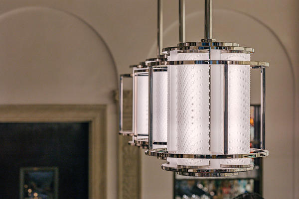 Bespoke Lalique Coutard Pendants illuminating the bar area.