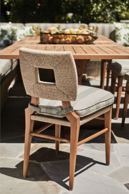 Hand-woven all-weather rush and teakwood are a beautiful, sturdy combination. The How To Marry A Millionaire side chair comes in Sand (shown) and also Charcoal.