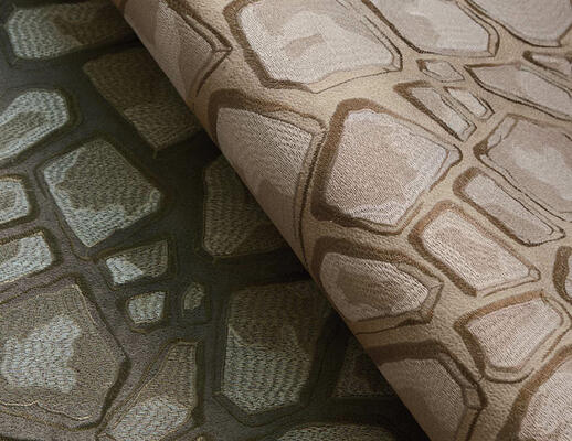 Faux suede intricately stitched in complementary colors creates the Rocks collection’s trompe l’oeil effect. Artful tonal shifts produce an interplay of shadows and angles that lend depth and detail to the pattern, the sheen of the embroidery enhancing its dimensional quality. Available in two colorways.
