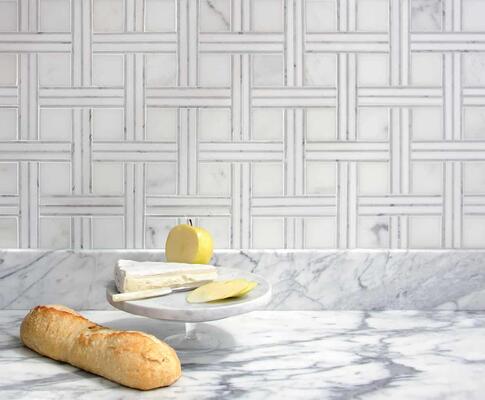 Jennifer, a hand-cut mosaic in polished Calacatta, Thassos and Carrara, is part of the Studio Line by New Ravenna.