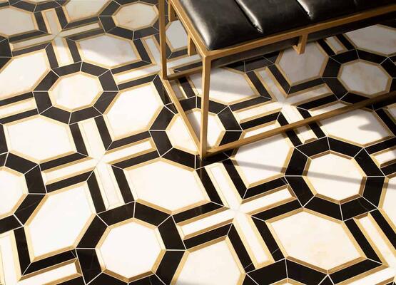 Tristan, a water-jet stone mosaic in polished Nero Marquina and honed Calacatta Monet with brushed Brass, is part of the Studio Line of ready-to-ship mosaics by New Ravenna.