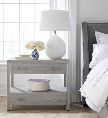 From the versatile Ariel collection of grasscloth-wrapped pieces, the two-drawer nightstand in new gray finish. Offered in four finish options with hardware in stainless steel or satin brass so you can choose to suit the decor.