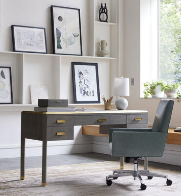 From our Berkley collection of sophisticated pieces with luxe shagreen texture, the expansive Berkley desk can make any space a stylish home office. Choose taupe finish with brushed-brass trim or gray with pewter trim.