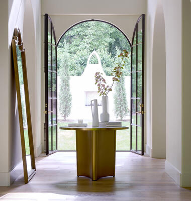 Georgia entry table: sleek and stylish, with a finely crafted top of Italian Carrara marble and brass inlay featuring a curved motif that complements the design of the sculptural pedestal base. Also available as a coffee table.