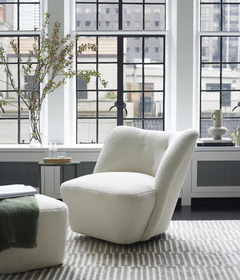 The midsize Scandinavian-inspired Griffen swivel chair and matching ottoman. Customizable in fabric or leather.
