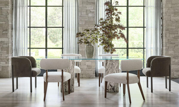 Onyx dining table, with a stunning double-pedestal onyx base and simple tempered-glass top. Surrounded by new seating: Odele arm chair and Walsh side chair, both customizable in fabric or leather and in all MG+BW wood finishes.