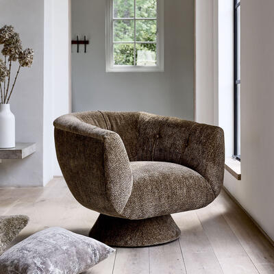 The fully upholstered Vivian Studio swivel chair, featured in Brixton-Bronze, a Kravet fabric.