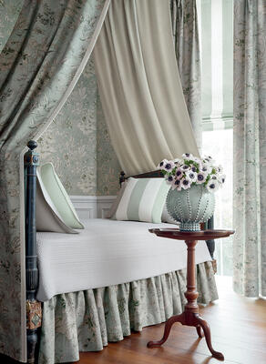 Rosalind wallpaper in mist, bed canopy and skirt in Rosalind printed fabric in mist, pillows in Bergamo Stripe fabric in mist