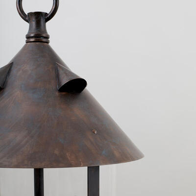 Hand-fabricated and finished in copper bronze, the Axford lantern is fitted with a single cylindrical glass shade.