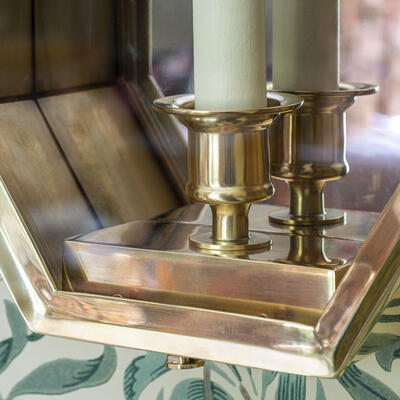 The antiqued brass finish of the Ovington wall lantern achieves a warm patina that will age beautifully over time.