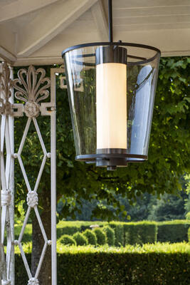 An inner cylinder of opaline glass encased by a hand-blown glass shade distinguishes the elegant, streamlined Zurich outdoor lantern. UL Listed for Wet Locations.