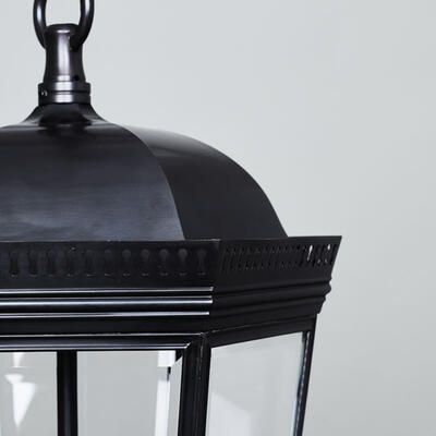 The Bentworth lantern features decorative pierced metalwork, a curved hood and beveled glass.