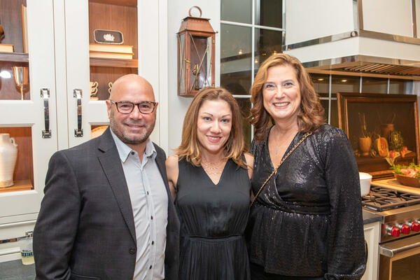 Grayson Pratt (center) of Grayson Pratt Interiors, who designed the loggia and pool deck, is pictured with Paul and Stacie Kennedy.