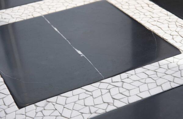 Avenue, a hand-cut stone mosaic shown in venetian honed Nero Marquina and tumbled Thassos, is part of the Heritage collection by New Ravenna.
