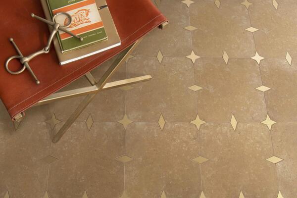 Beacon, a water-jet stone mosaic shown in honed Lavigne and Brass, is part of the Heritage collection by New Ravenna.