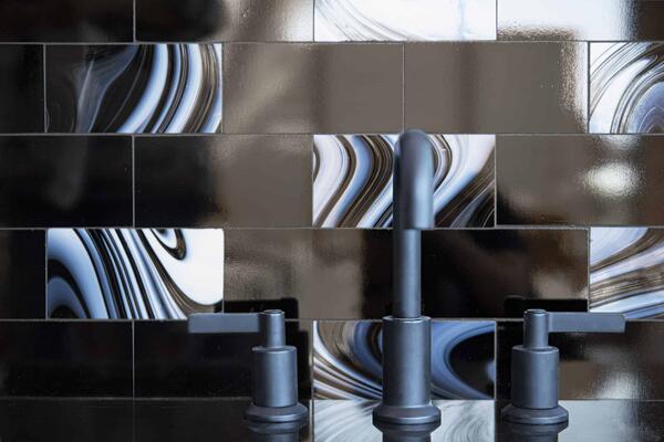 Bricks 3″x6″, a hand-cut jewel glass mosaic shown in Obsidian and Jet, is part of the Heritage Collection by New Ravenna.