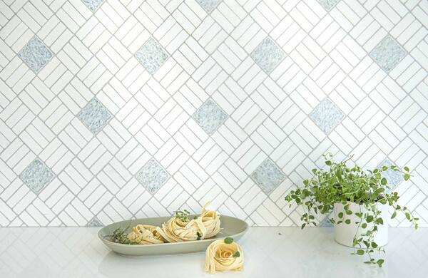 Oxford Weave, a hand-cut stone mosaic shown in tumbled Thassos and Cielo, is part of the Heritage collection by New Ravenna.