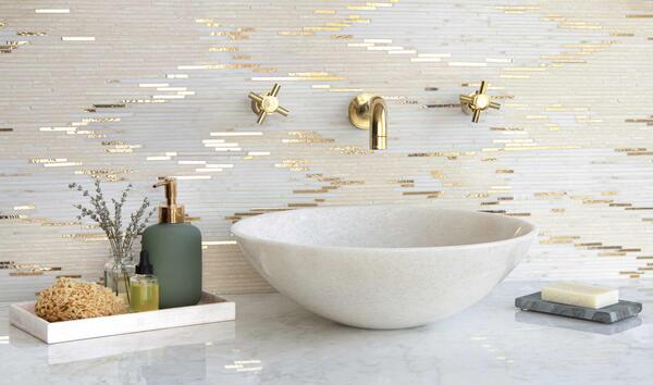 Reve d’Or, a hand-cut stone mosaic shown in honed Aurum, Calacatta Monet, Travertine White and polished Aurum, is part of the Heritage collection by New Ravenna.
