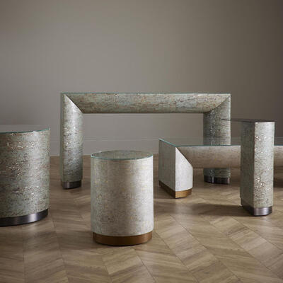 Wrapped in tiles of thinly sliced cork over a metallic substrate, these five Ambrose accent tables come in two beautiful finishes that let subtle sheen show through. Metal trim completes the look. Tempered-glass tops included.