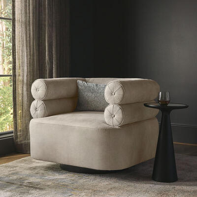 From celebrated designer Brigette Romanek, the Lucy swivel chair brings a statement-making focal point to a room. Two rows of distinctive bolster-like cushioning reflect its Art Deco influences. Customizable in fabric or leather and set on a round metal swivel base available in a choice of finishes.