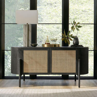 Organic yet modern, the Tate buffet features a rich mix of materials. Woven cane door panels bestow natural texture and an airy feel to the Carbon-finished curved oak cabinet. Pair it with the Tate dining table for a cohesive look.