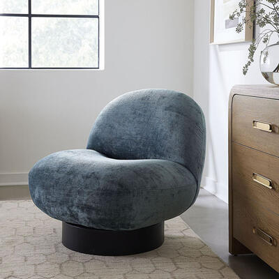 The luxe Hatcher armless swivel chair, sustainably hand-crafted in North Carolina, epitomizes cozy comfort. Well-padded to hug your back, it invites relaxation. Customize it in 500-plus fabrics, including performance textiles, and more than 20 wood base finishes.