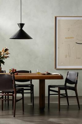 “Indirect,” a work of art by Dan Hobday, hangs behind the Anita dining table and Joan dining chairs