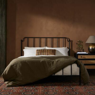 Four Hands’ Zara iron bed and hand-knotted Hingol rug