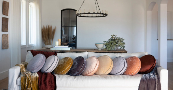 Assortment of new 18-inch-diameter round pillows in several colors and fabric collections