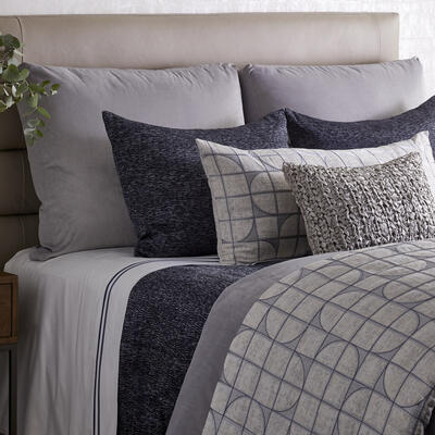 Named after its graceful design, Capsule features soft gray, blue and charcoal embroidery on a silvery jacquard. Available as a duvet, pillows and throw. 54% viscose, 20% acrylic, 16% cotton, 10% polyester