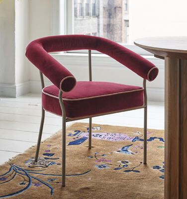 From the Rafael de Cárdenas for MG+BW Home collaboration: Stiletto dining armchair with brushed stainless frame, shown in Kravet Maroon Ford velvet with Blush Ford velvet contrast welt 