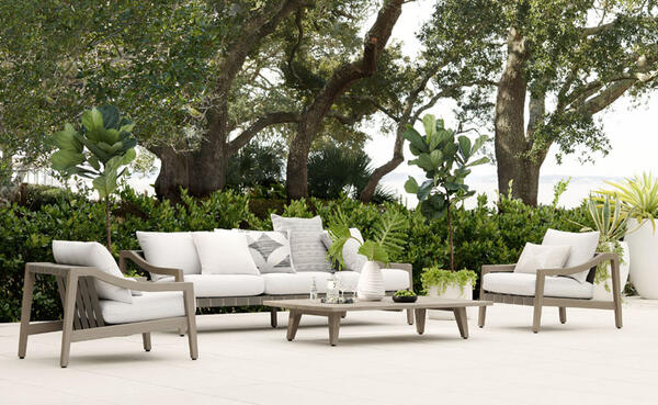 Del Mar sofa, lounge chairs and coffee table in sustainably sourced natural teak with cushions shown in Oyster performance basket weave. Customizable in 18 outdoor performance fabrics