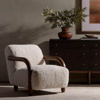 The new Aniston chair contrasts plush faux Mongolian shearling with a chunky wire-brushed wood frame for a warm, vintage feel