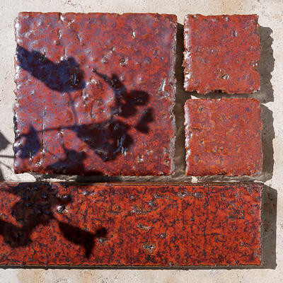 Miyabi series glazed porcelain featured with torn-edge field and textured brick tile in Plum Red from the Zen+Clay collection, Heritage Tile